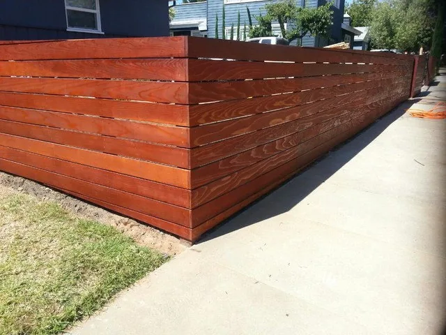 Stained wood fence on a sloped lot