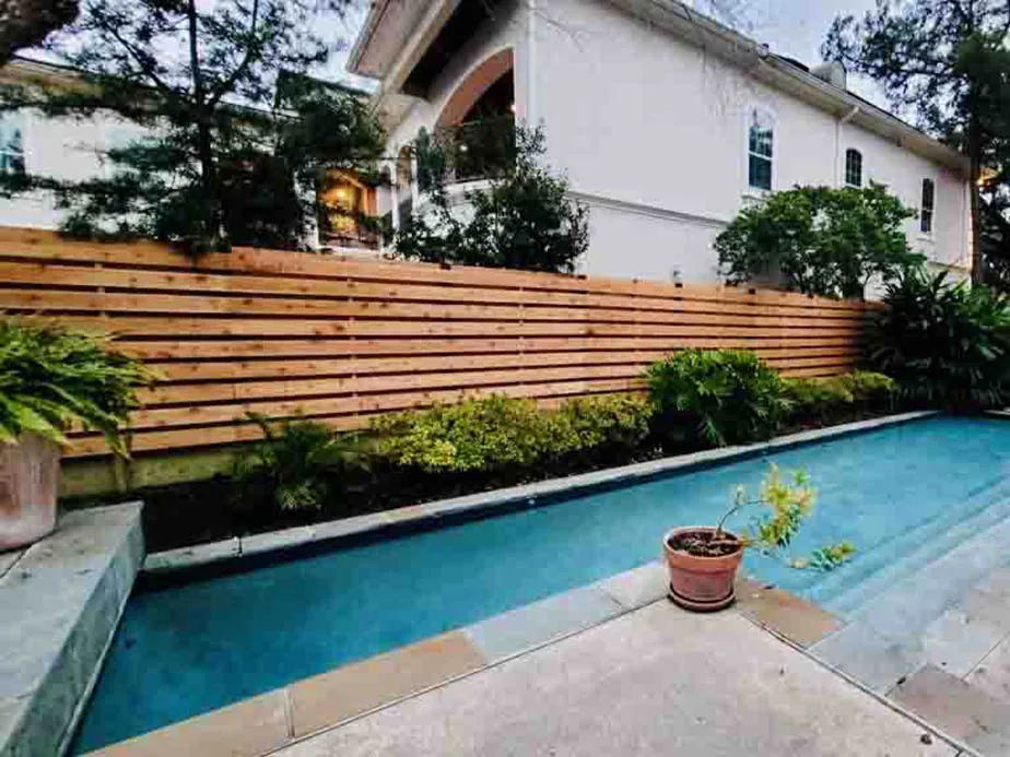 Finished cedar fence run with cap rail